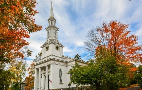 Daytime building with fall foliage