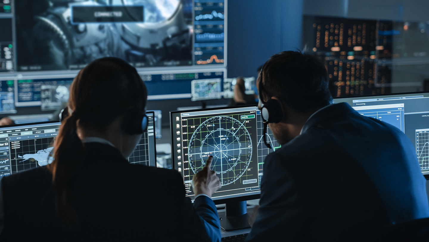 people analyzing info in a control room